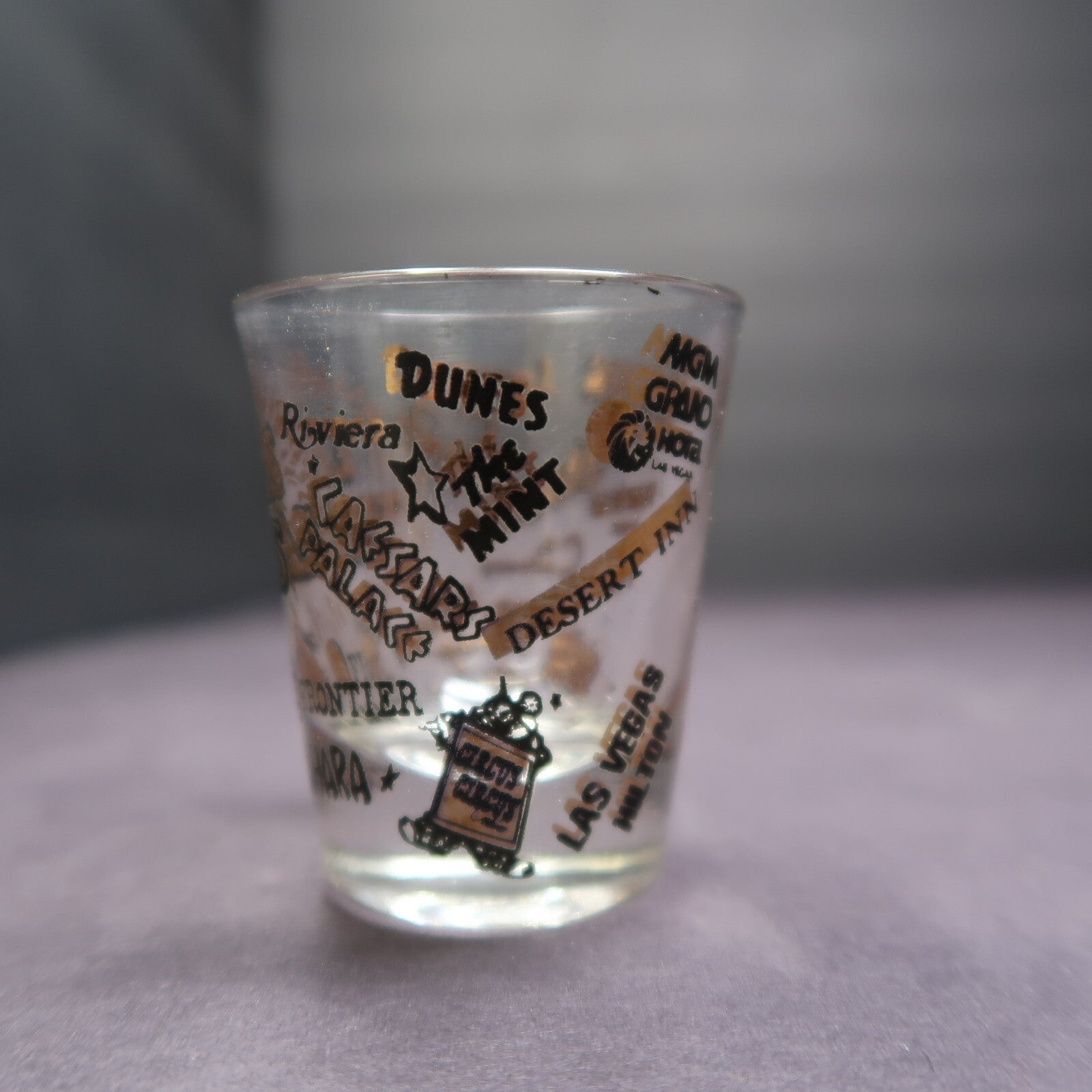 Vintage Las Vegas Souvenir Shot Glass Casino Names Black and Gold on Clear