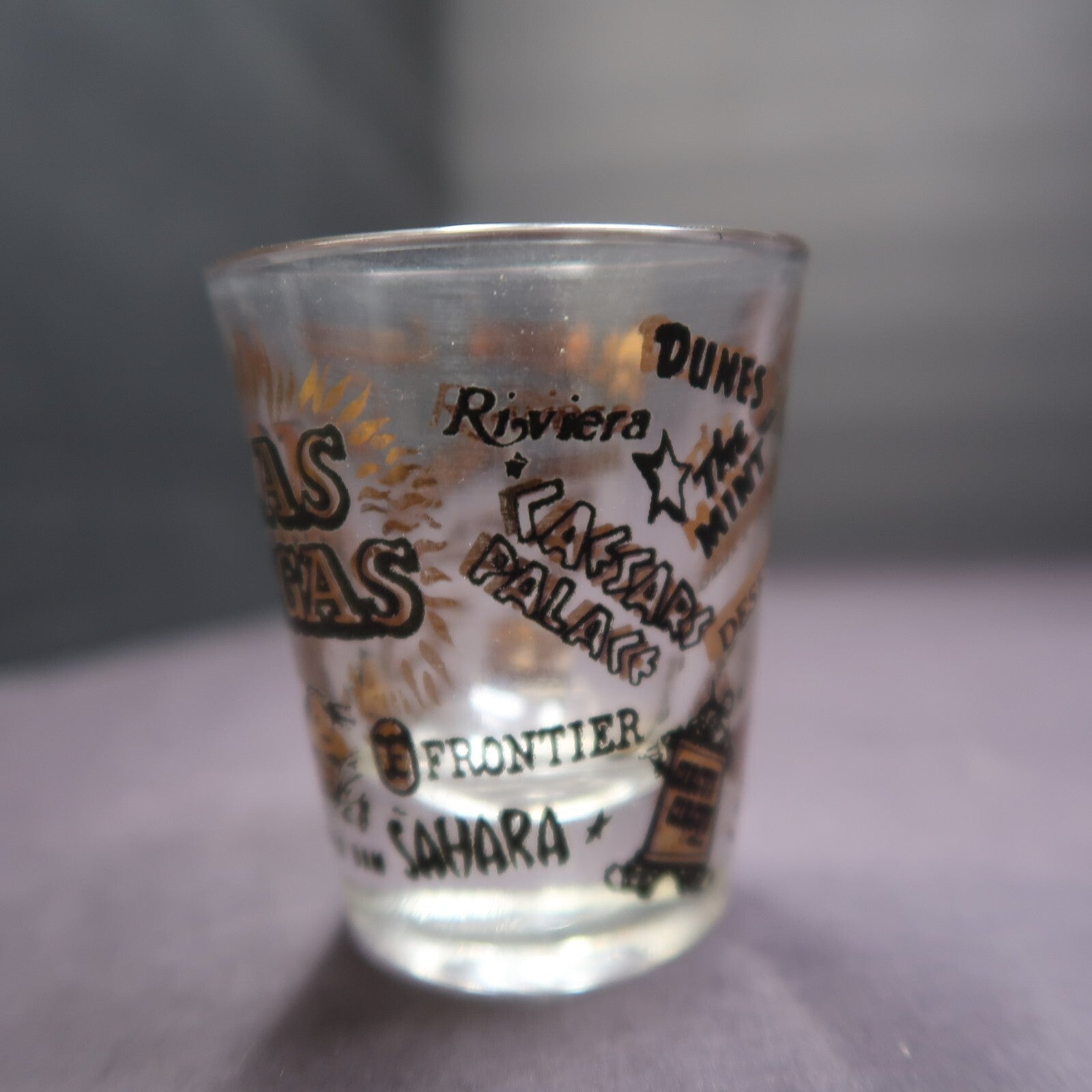 Vintage Las Vegas Souvenir Shot Glass Casino Names Black and Gold on Clear