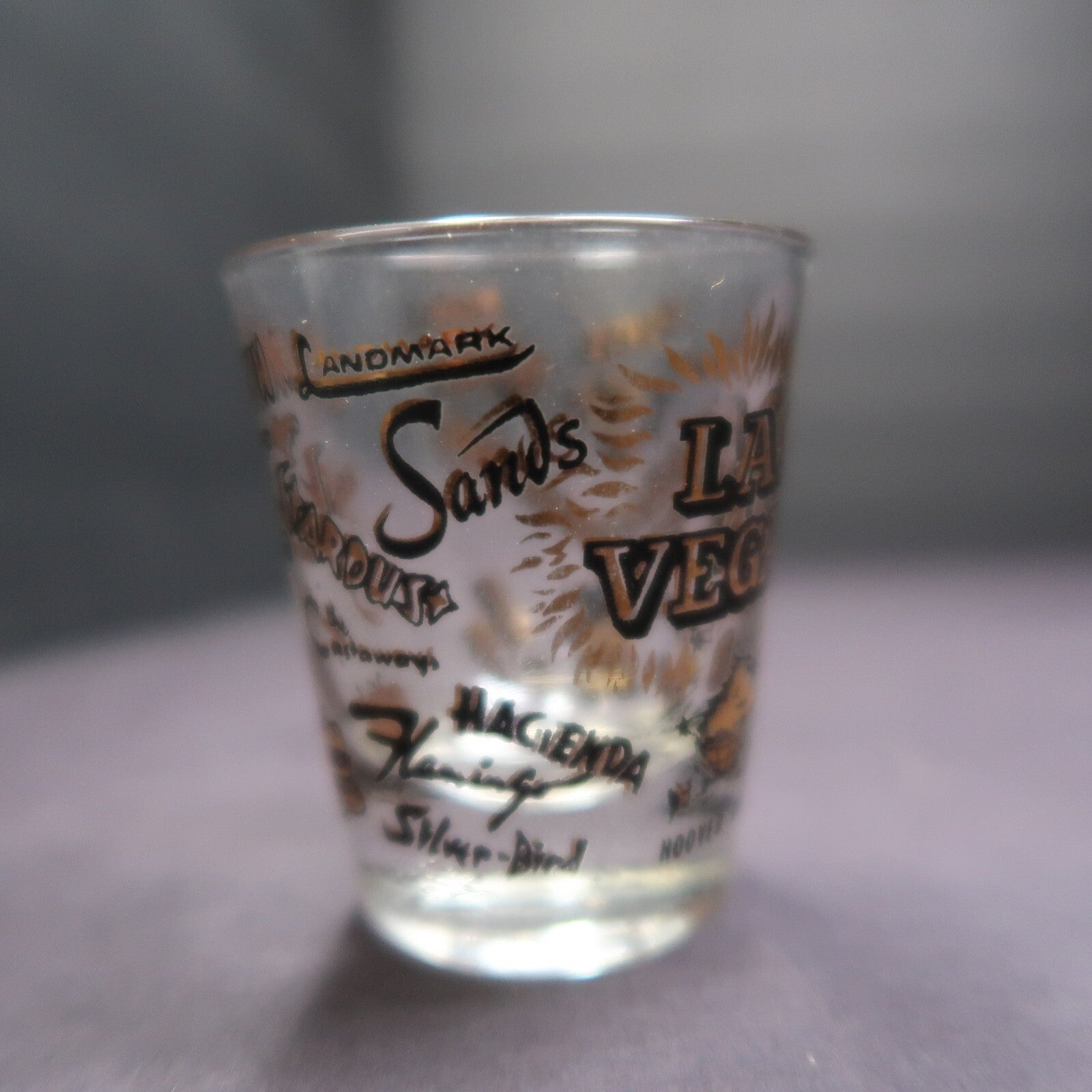Vintage Las Vegas Souvenir Shot Glass Casino Names Black and Gold on Clear