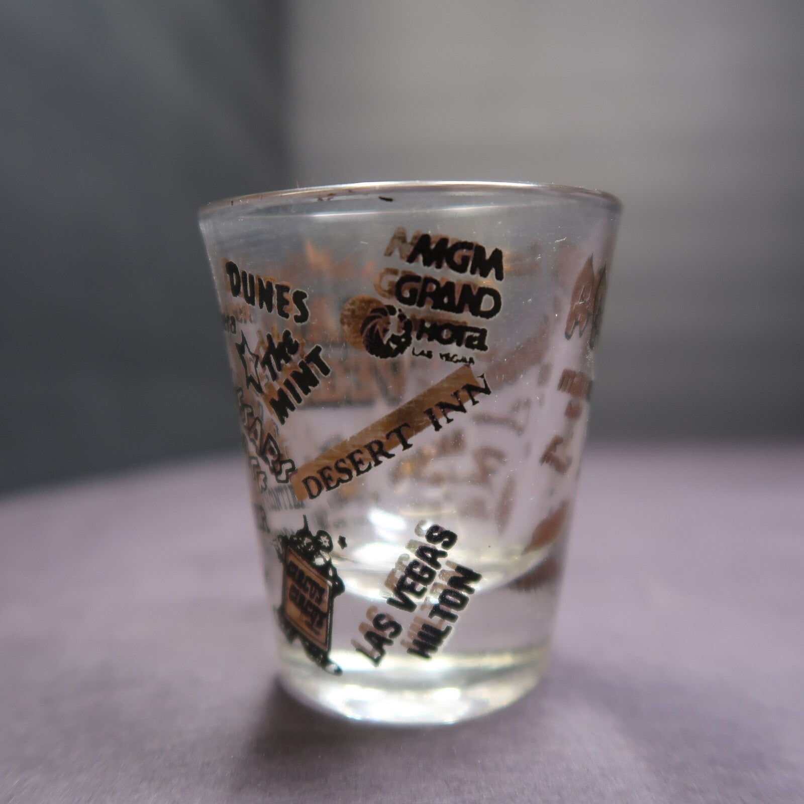 Vintage Las Vegas Souvenir Shot Glass Casino Names Black and Gold on Clear