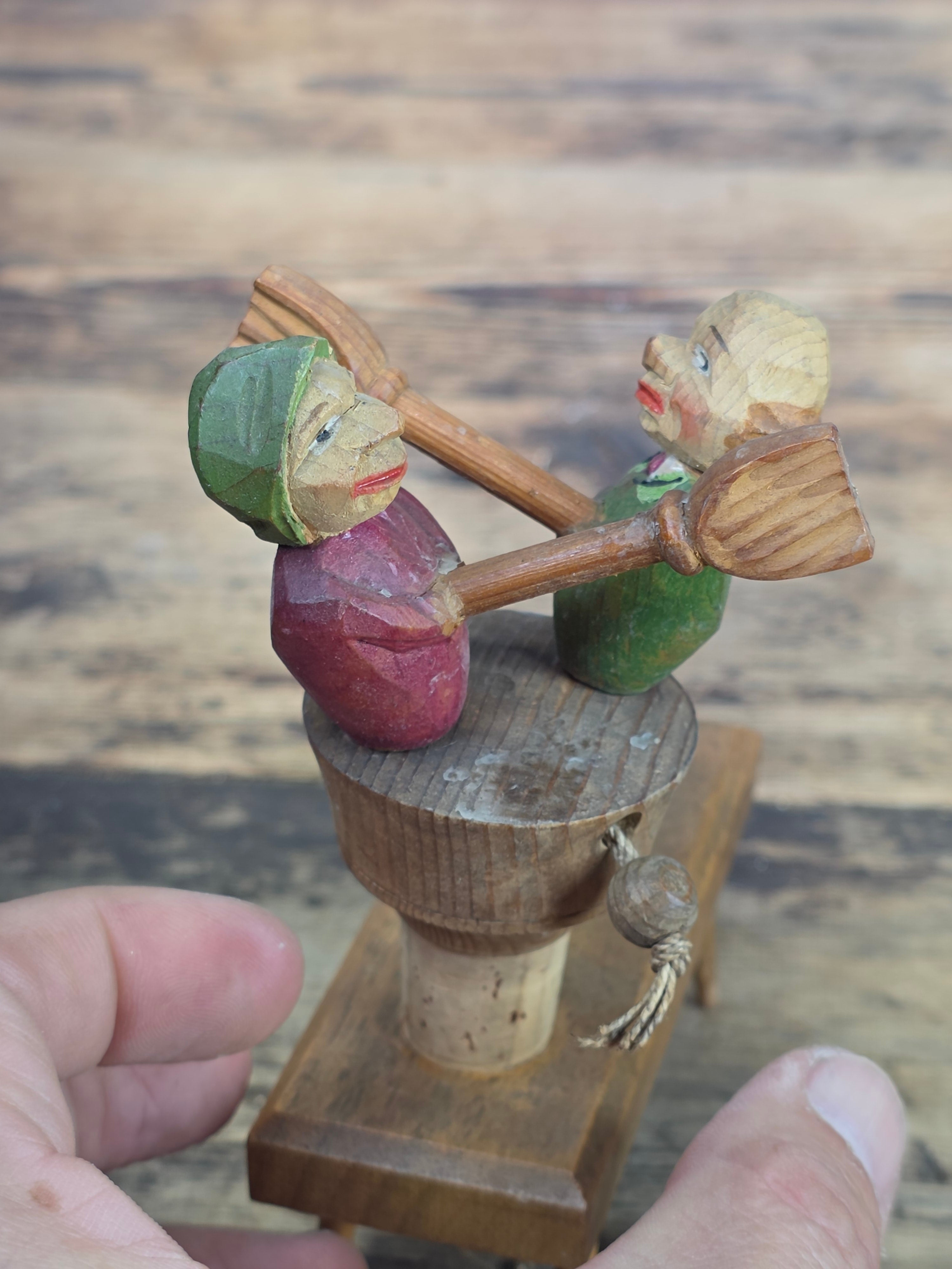 Vintage ANRI Wood Carved Mechanical Bottle Stopper Fighting Couple Brooms